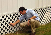 Jamie Ellis inspecting under a house